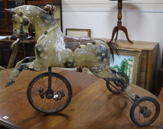 A Victorian painted pine and wrought iron horse tricycle height 67cm